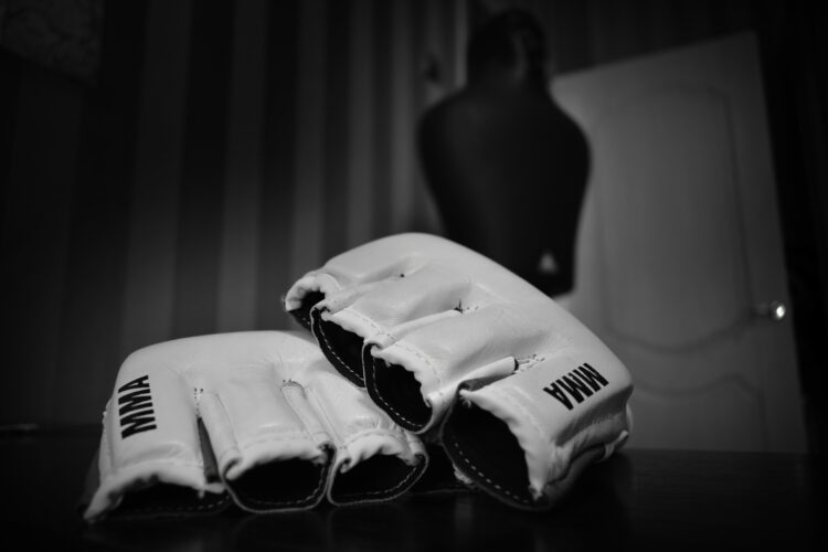 MMA Gloves with Training Dummy in Background